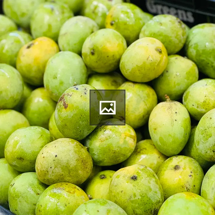 Green Mangoes in Crate
