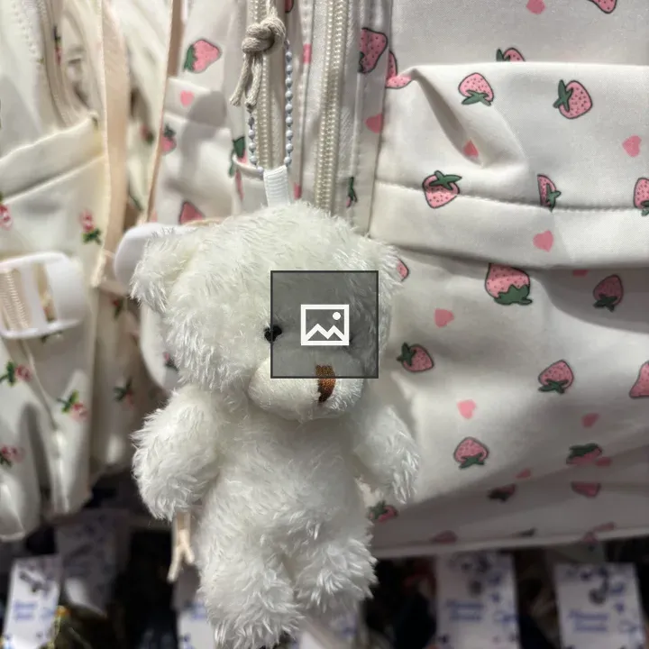 White teddy bear on pink bag