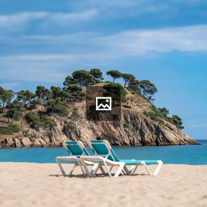 Two Sun Loungers on Beach