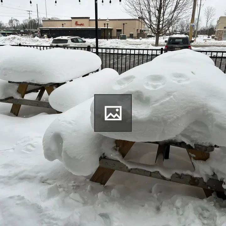 Snow on picnic tables