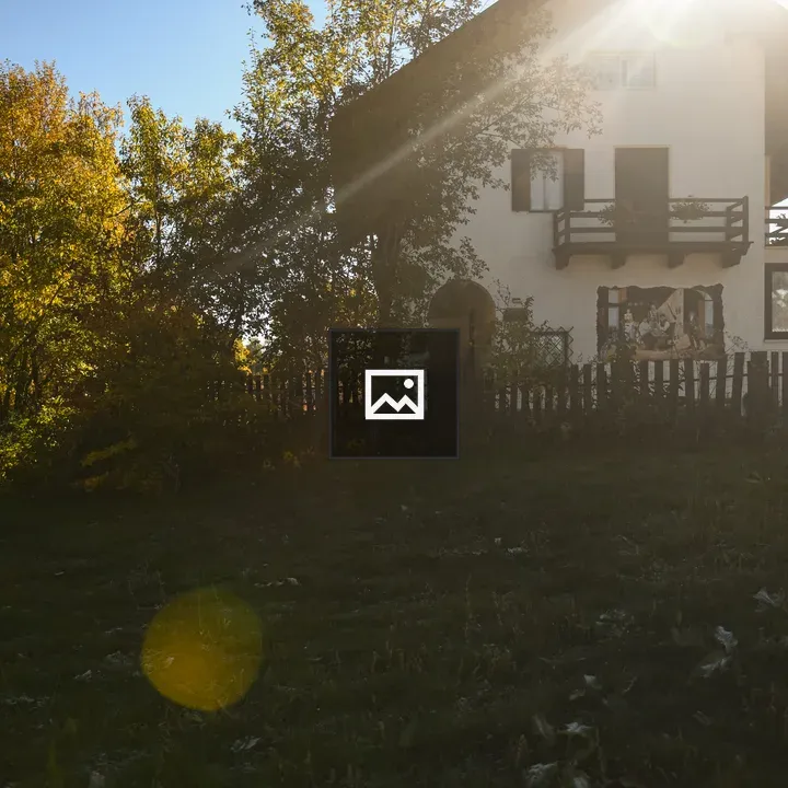 Quaint white house with autumn trees