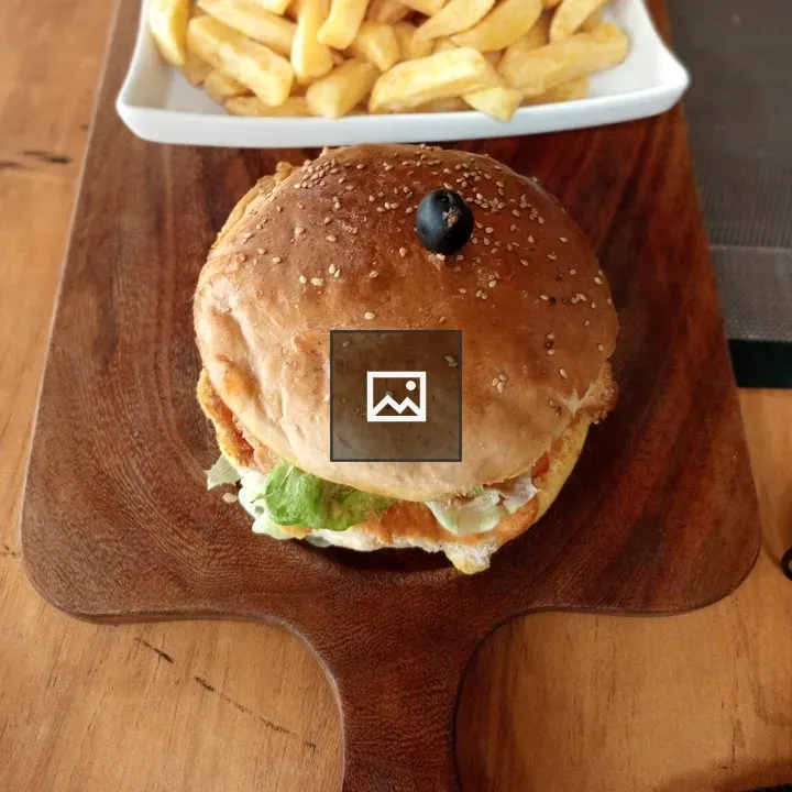 Chicken burger on wooden board