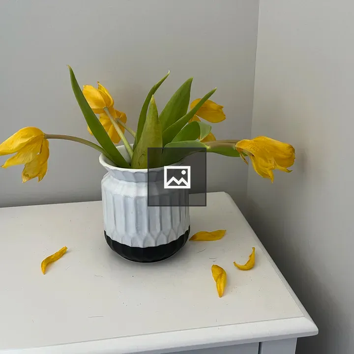 Nightstand with vase of tulips