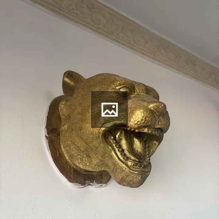 Golden lion sculpture on wall