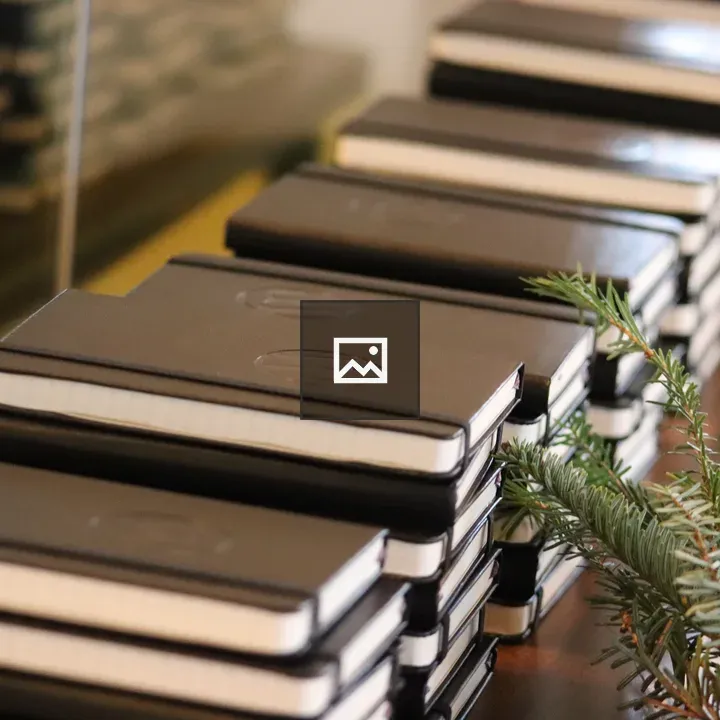 Stacks of notebooks with greenery