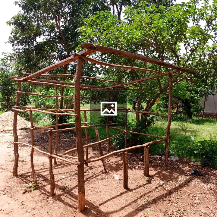 Small wooden shelter on red ground
