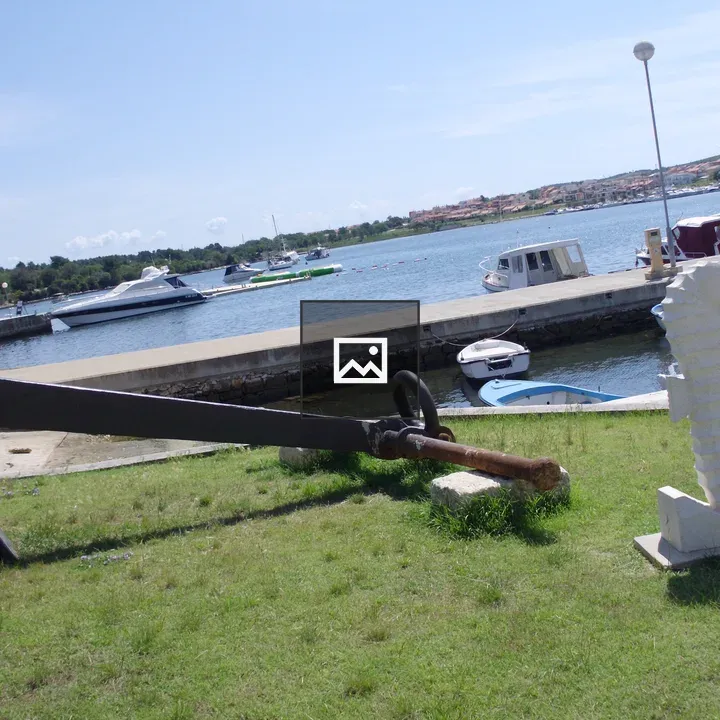 Anchor on Grass by Seaside