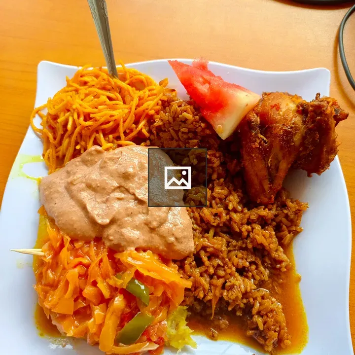 White plate with spiced rice and fried chicken