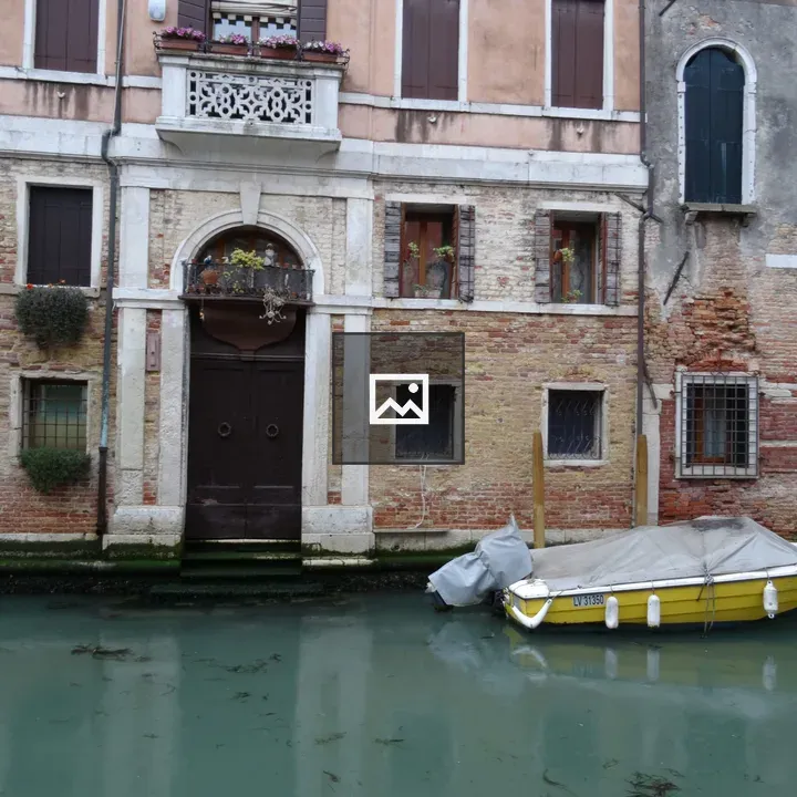 Canal scene with weathered brick building
