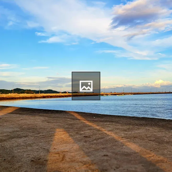 Beach scene with pier in distance