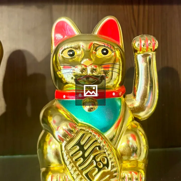 Golden cat figurine with bell