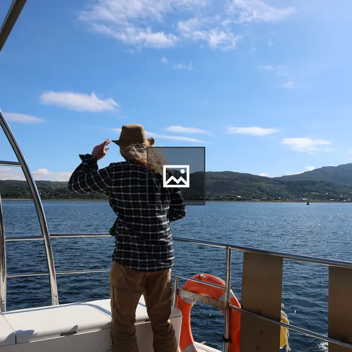 Man on boat looking seaward