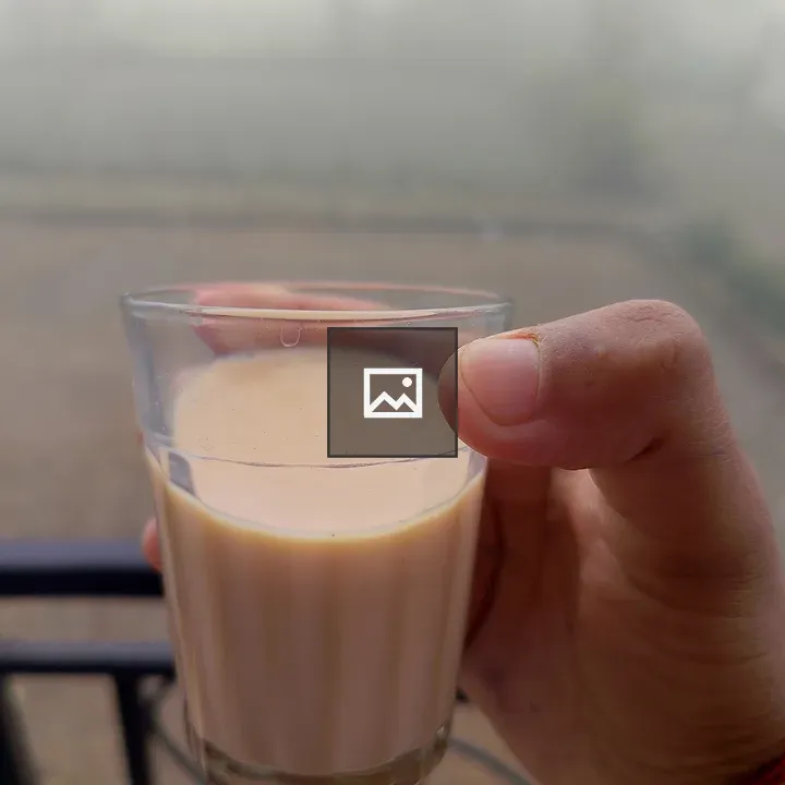 Hand holding cup of tea