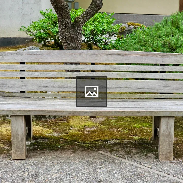 Wooden bench on garden path
