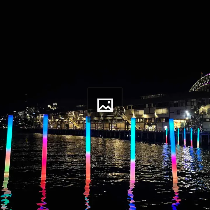 Night waterfront rainbow poles