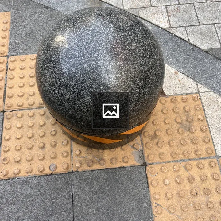 Granite Sphere on Patterned Pavement