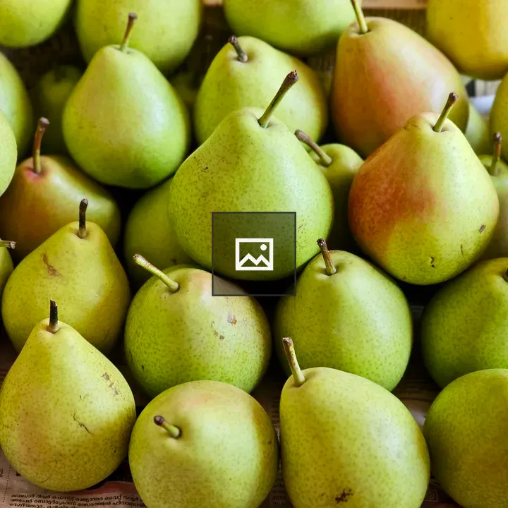 Fresh green pears on newspaper