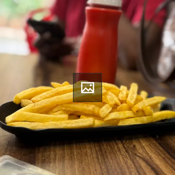 Plate of French Fries on Wooden Table