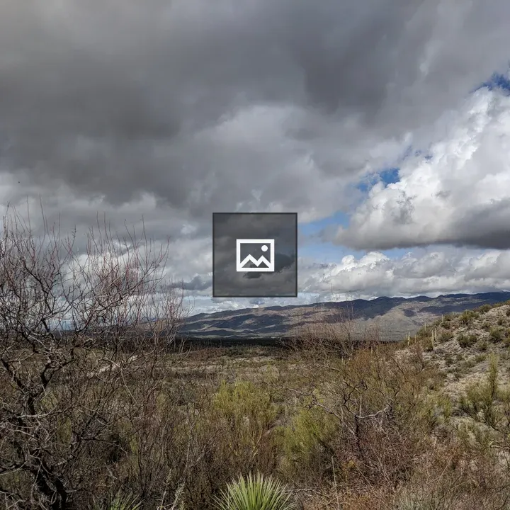 Low clouds over a desert hill