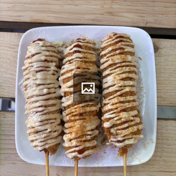 Three crispy corn dogs on a plate