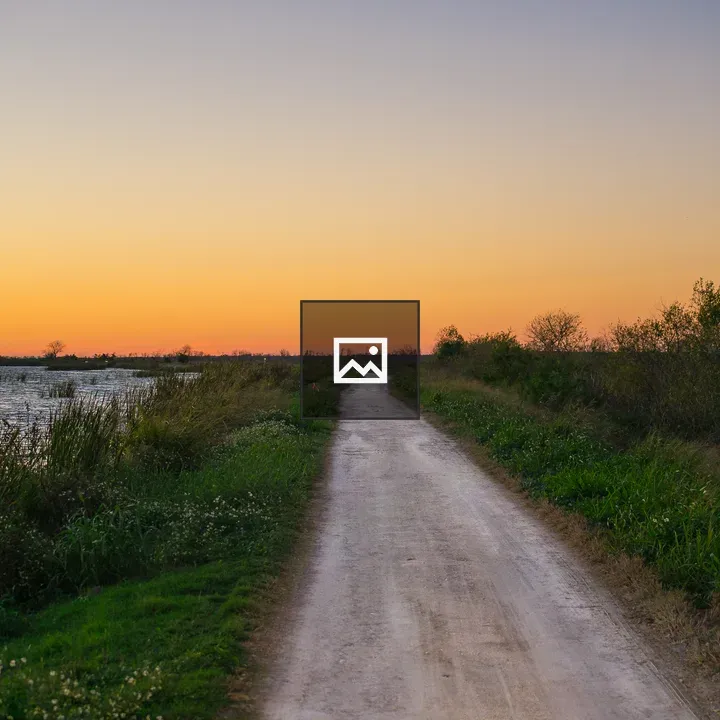 Sunset over lake on dirt road