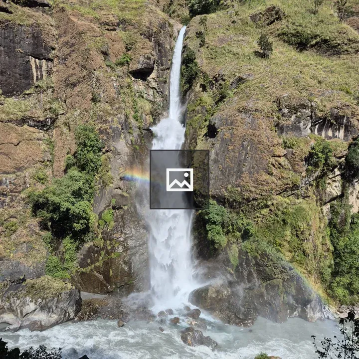 Waterfall in green cliff landscape