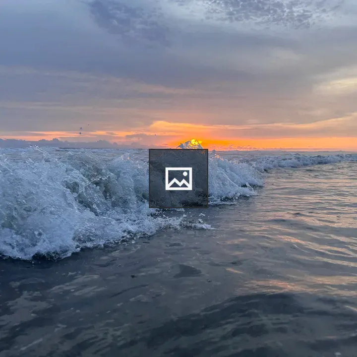 Wave crashing at sunset
