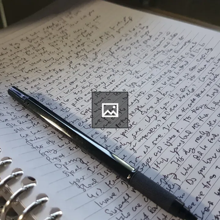 Writing text on paper with notebook and pen