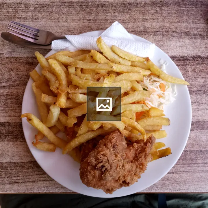 Fries, chicken, and coleslaw plate