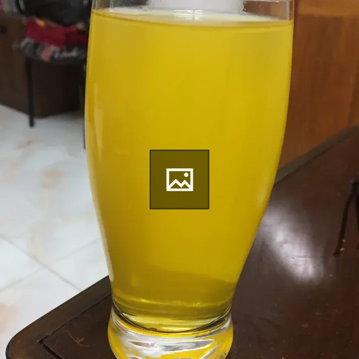 Yellow juice in clear glass