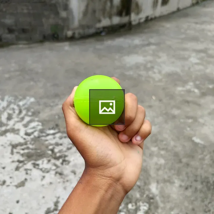 Hand Holding Green Ball