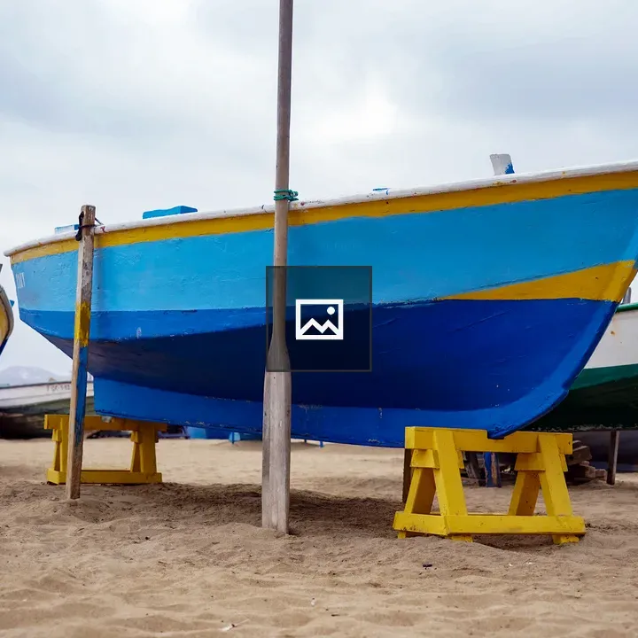 Blue fishing boat on beach