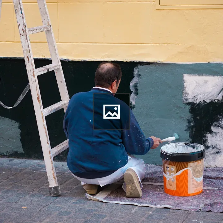 Person painting exterior wall