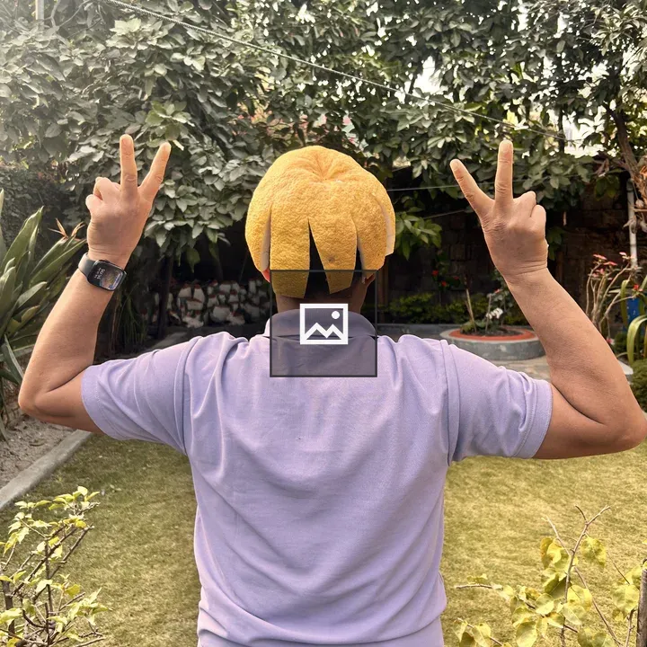 Person with yellow citrus hat in garden