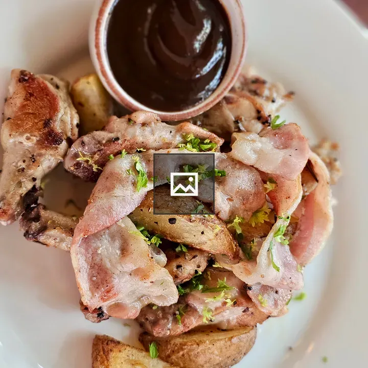 Plate of grilled chicken with bacon