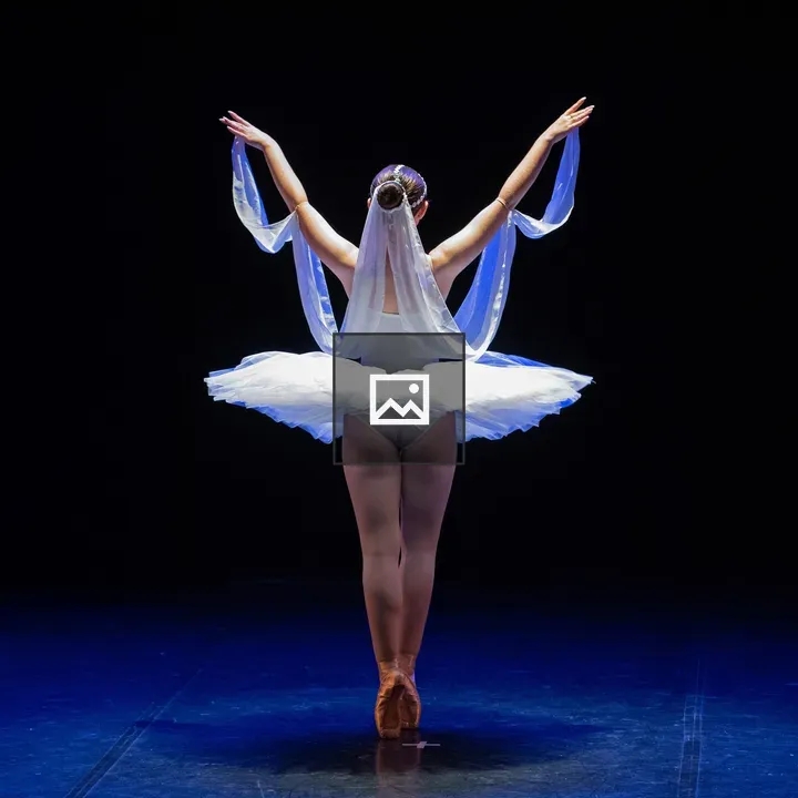 Ballerina on Stage in White Tutu