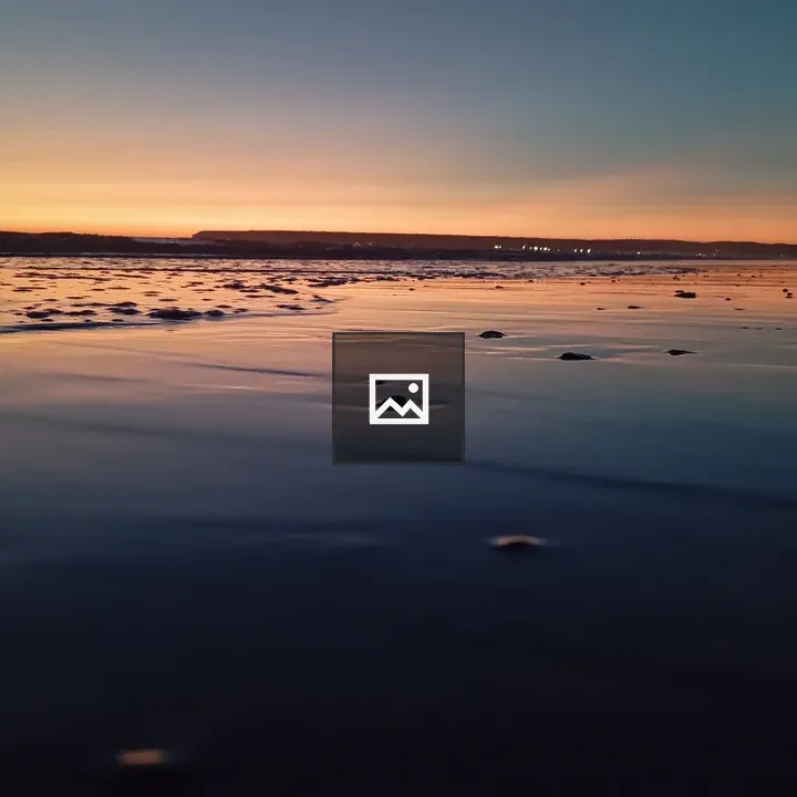 Sunset over calm shoreline