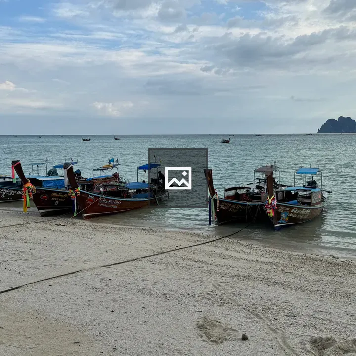 Longtail boats on white sand beach