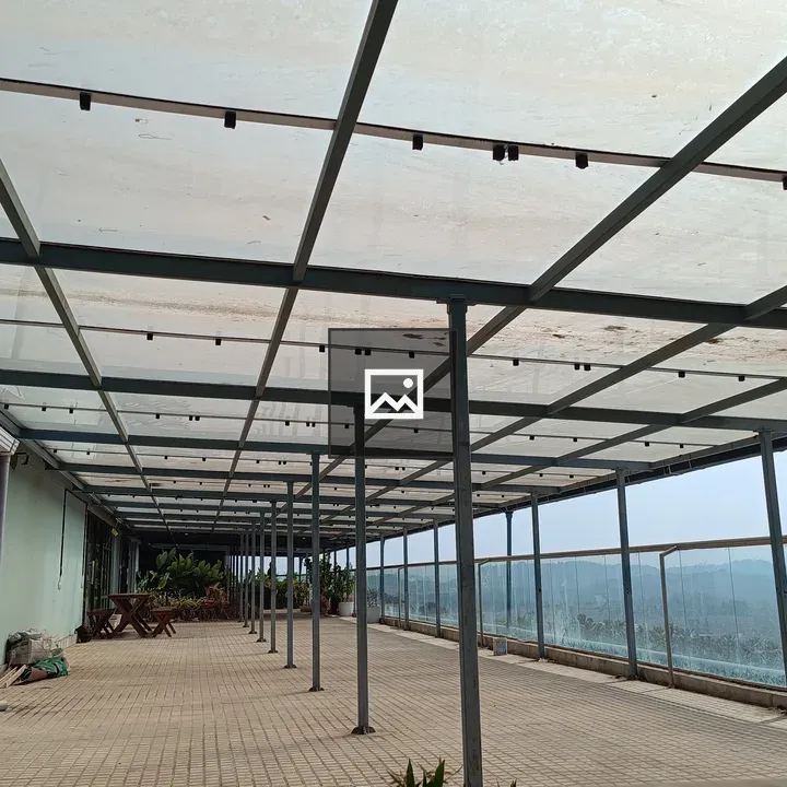 An empty balcony with glass roofing