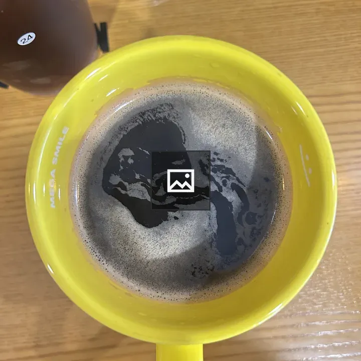 Yellow coffee mug on wooden table