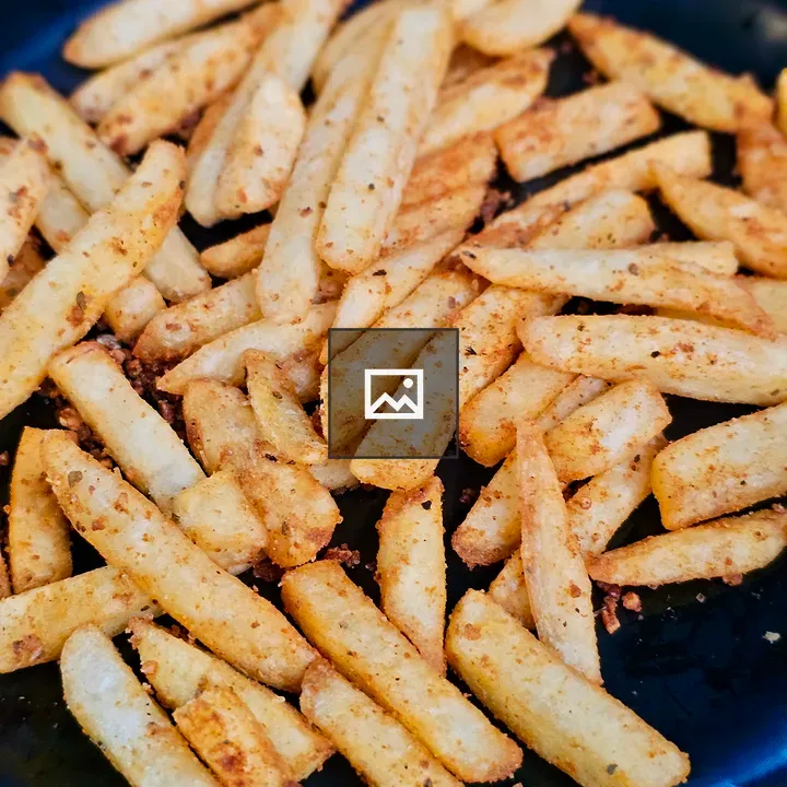 Potato sticks on black plate