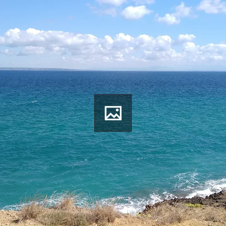 Cliffs Rising Over Blue Sea