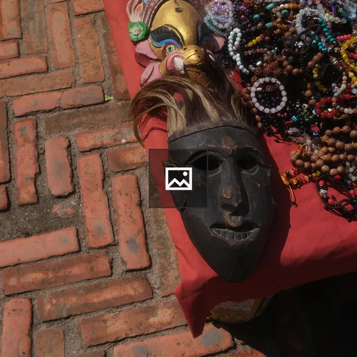 Ancient Face Mask on Red Cloth