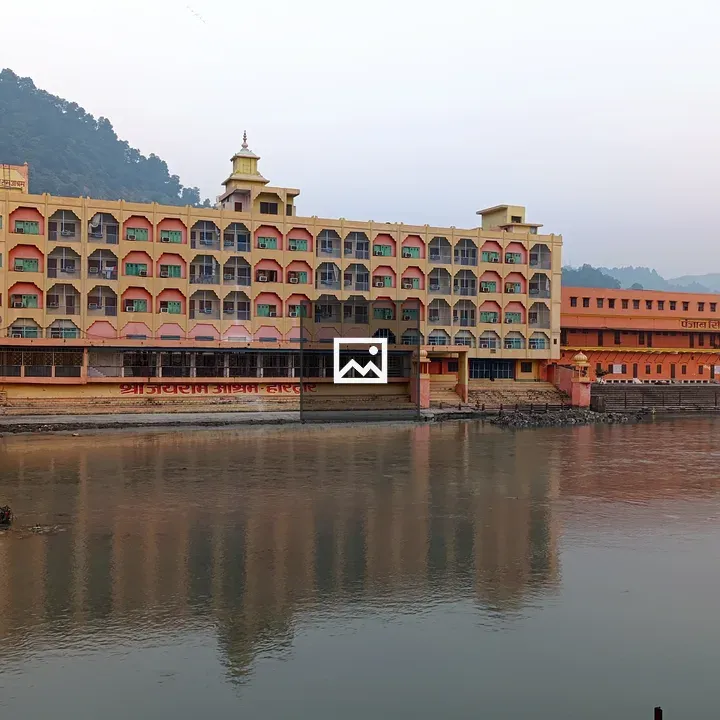 Haridwar building by river with bridge