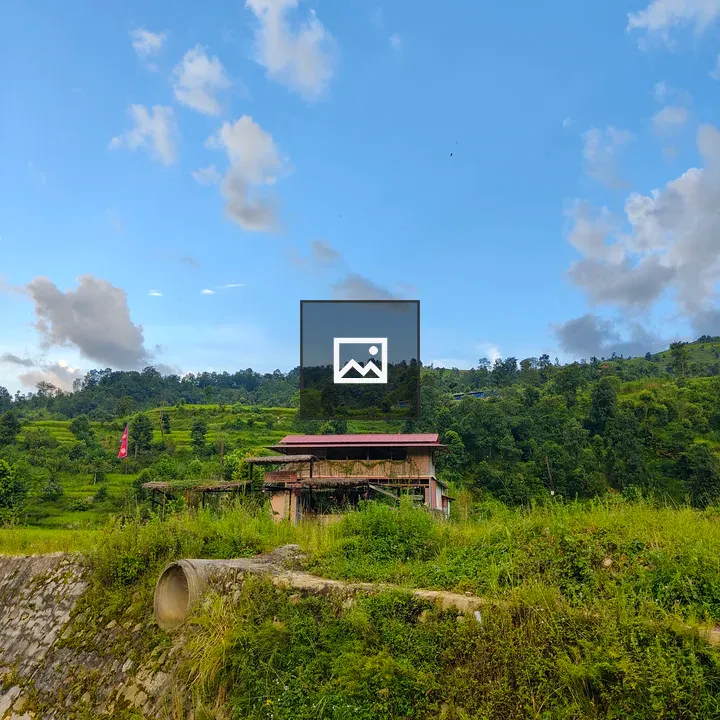 Rural house with red roof among green hills