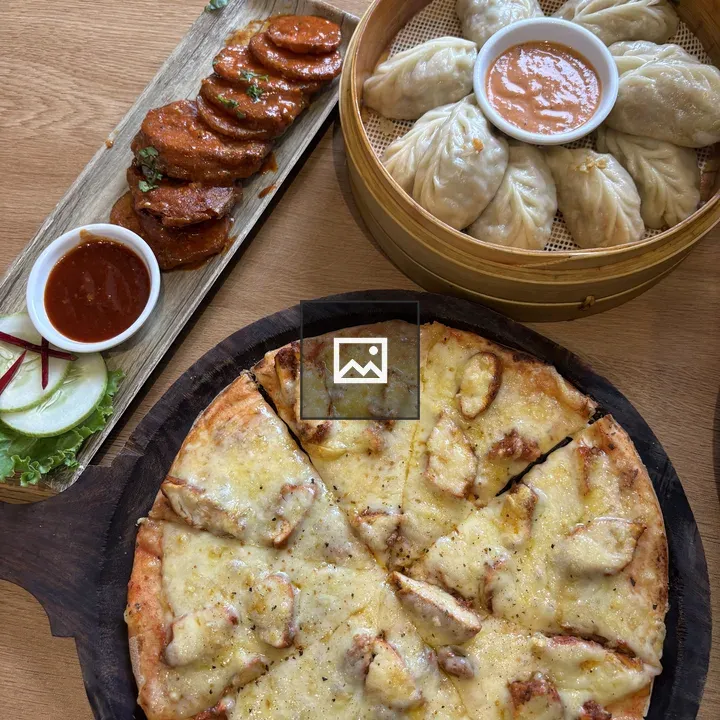 Wooden table with pizza and dishes
