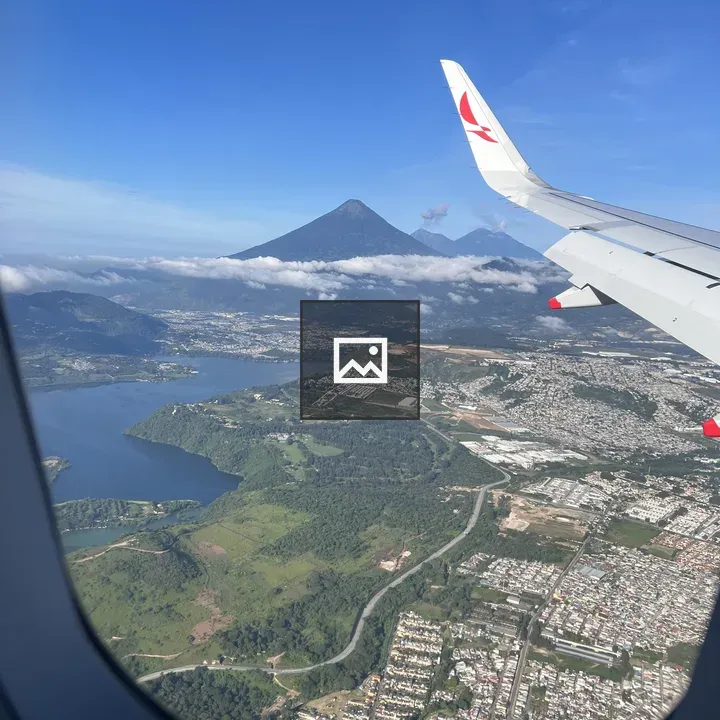 Volcanoes and village rooftops from airplane window