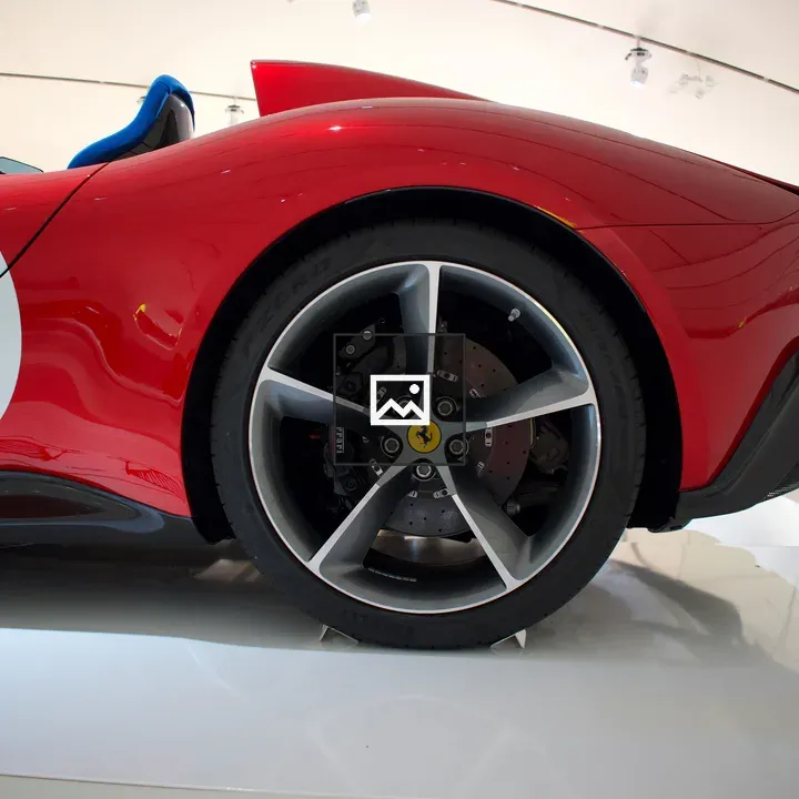 Red sports car rear wheel close-up