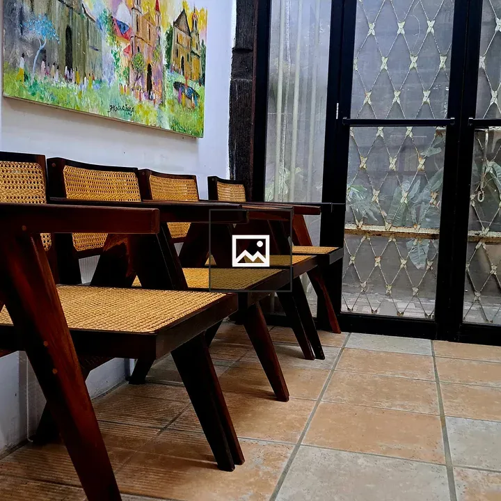 Row of Wooden Chairs with Cane Seats