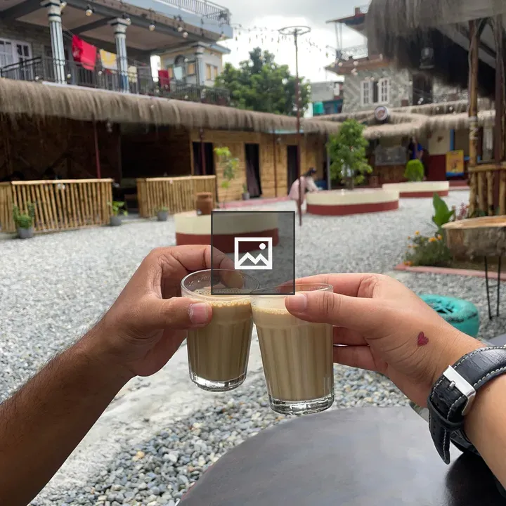 Two hands clinking milk tea glasses